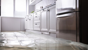 Flooded kitchen needing water damage restoration services in Falmouth